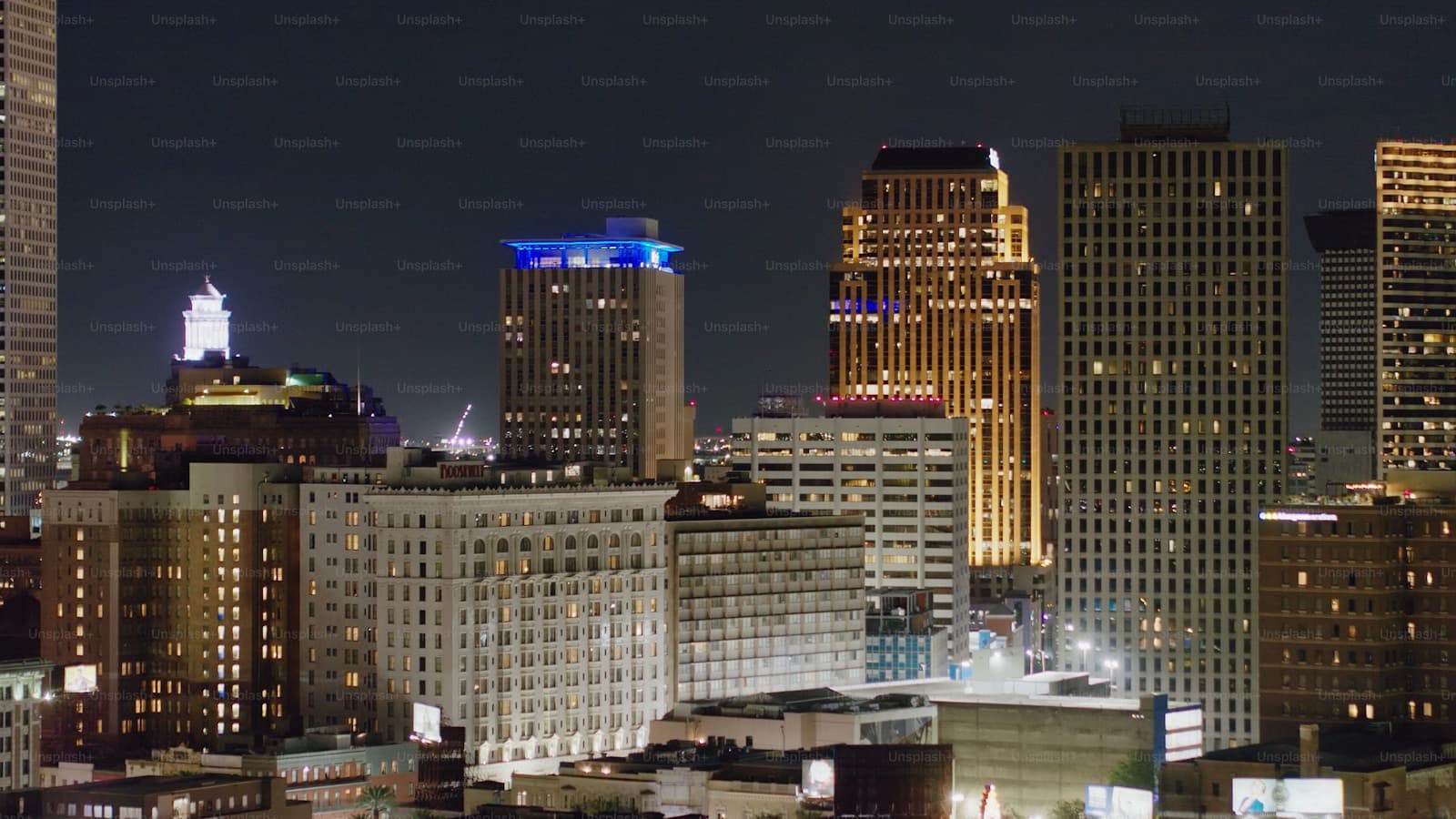 Night view of illuminated downtown city skyline with tall office buildings and skyscrapers
